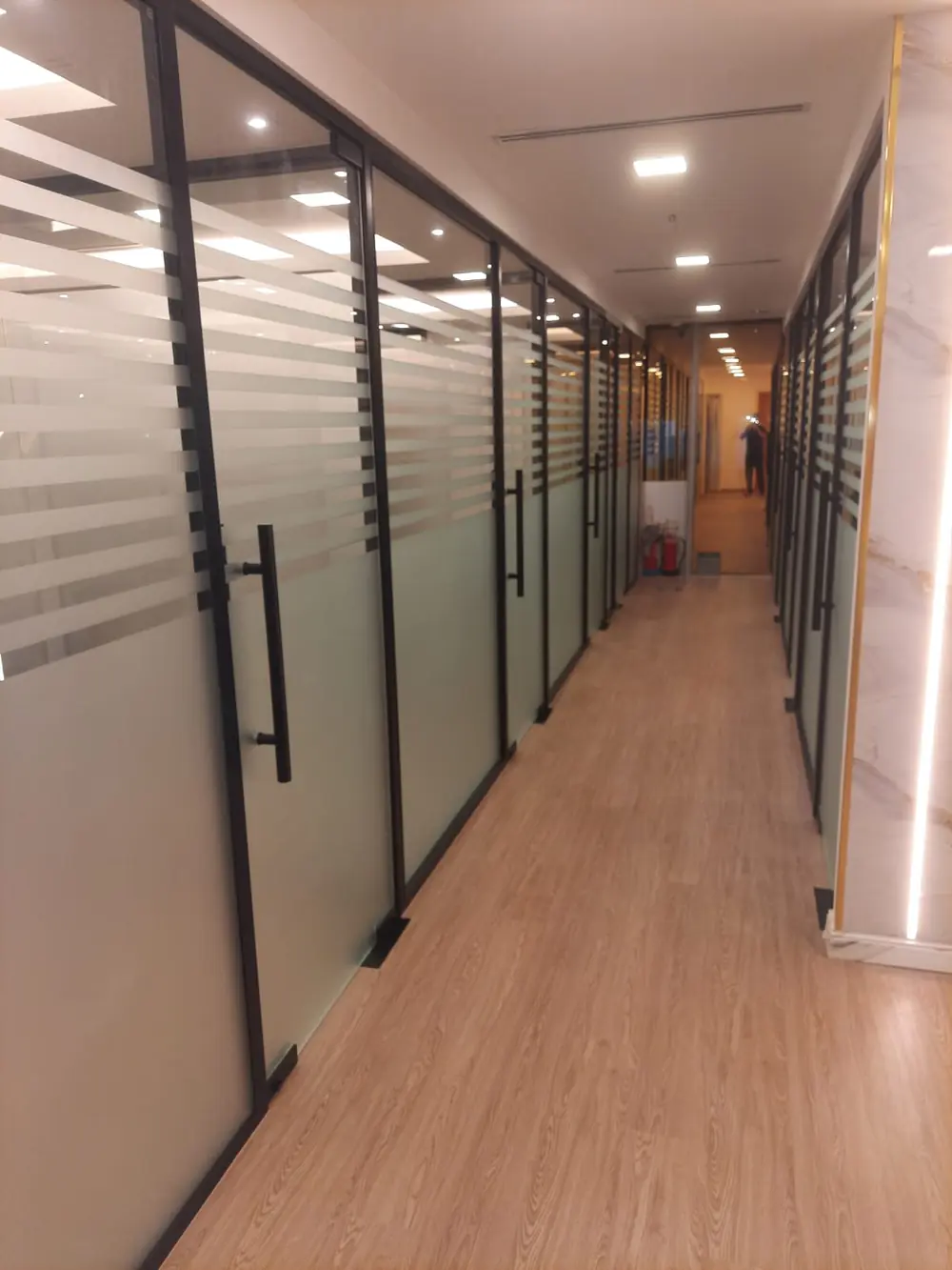 Office glass partition corridor with marble accent wall, Dubai