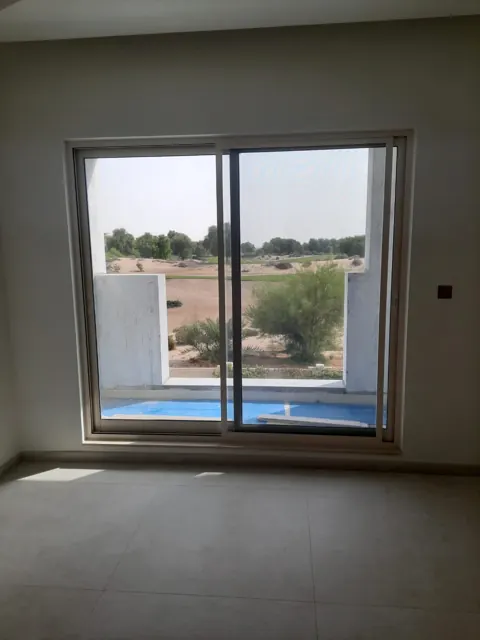A wide sliding window: A light-framed sliding window viewed from inside, with the exterior work still in progress.